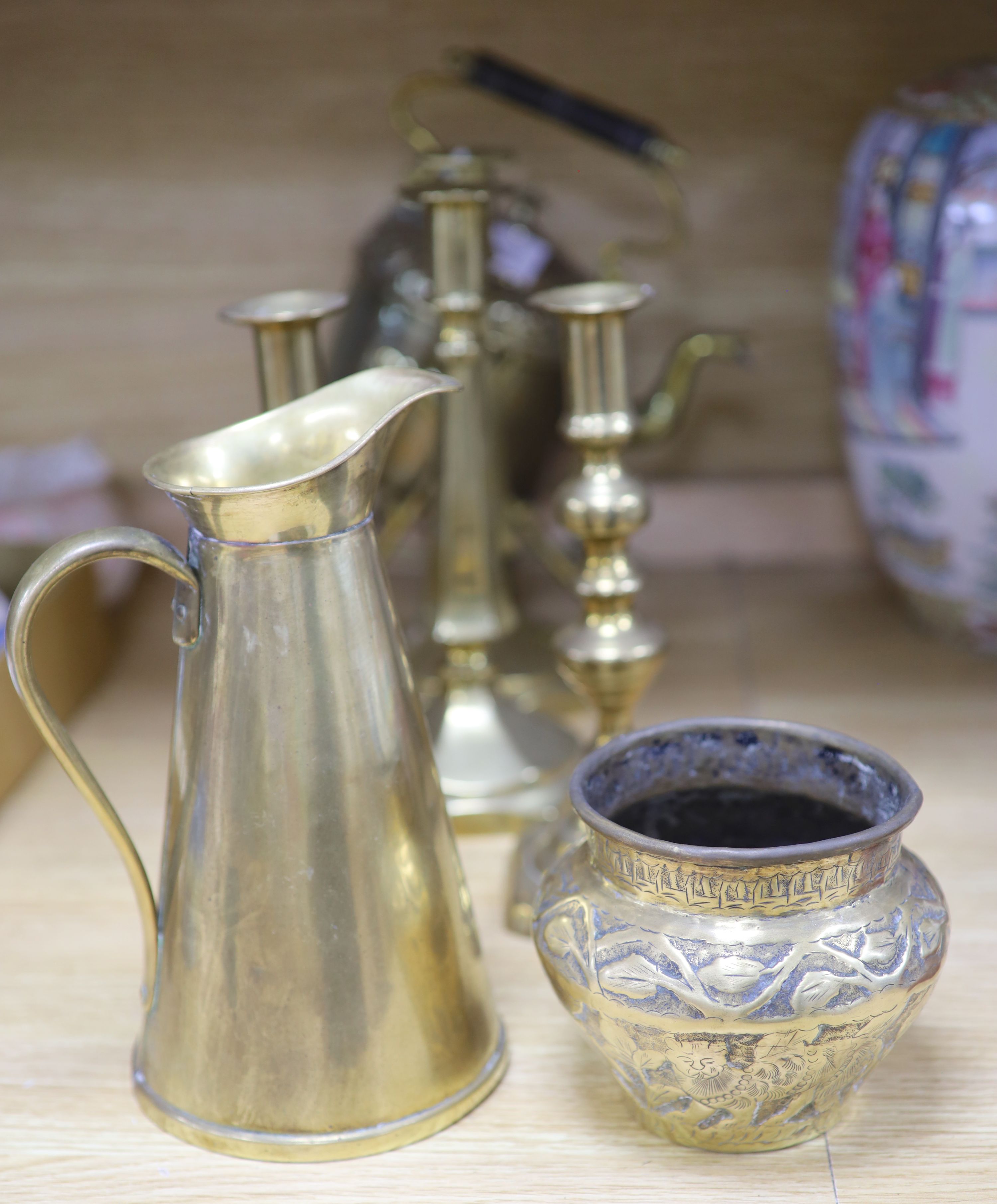 A Victorian brass spirit kettle on stand, two pairs of brass candlesticks and a jug